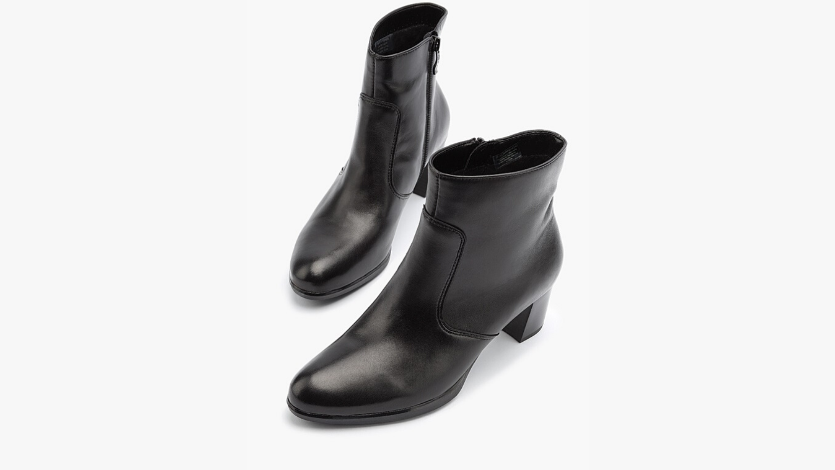 A pair of Ara women’s heeled black leather ankle boots against a neutral background.    
