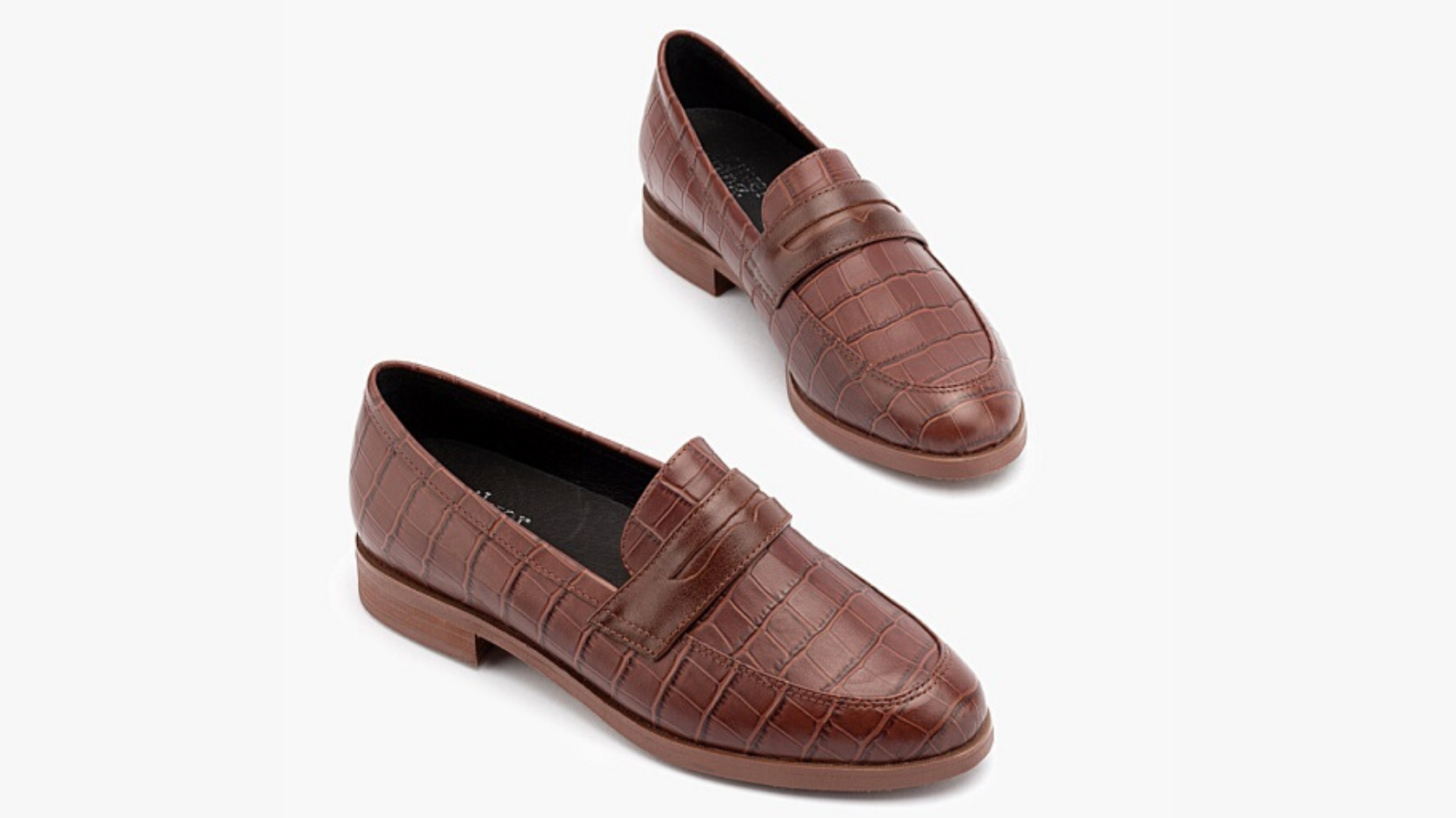 A pair of women’s faux crocodile-skin loafers in tan leather against a neutral background.  