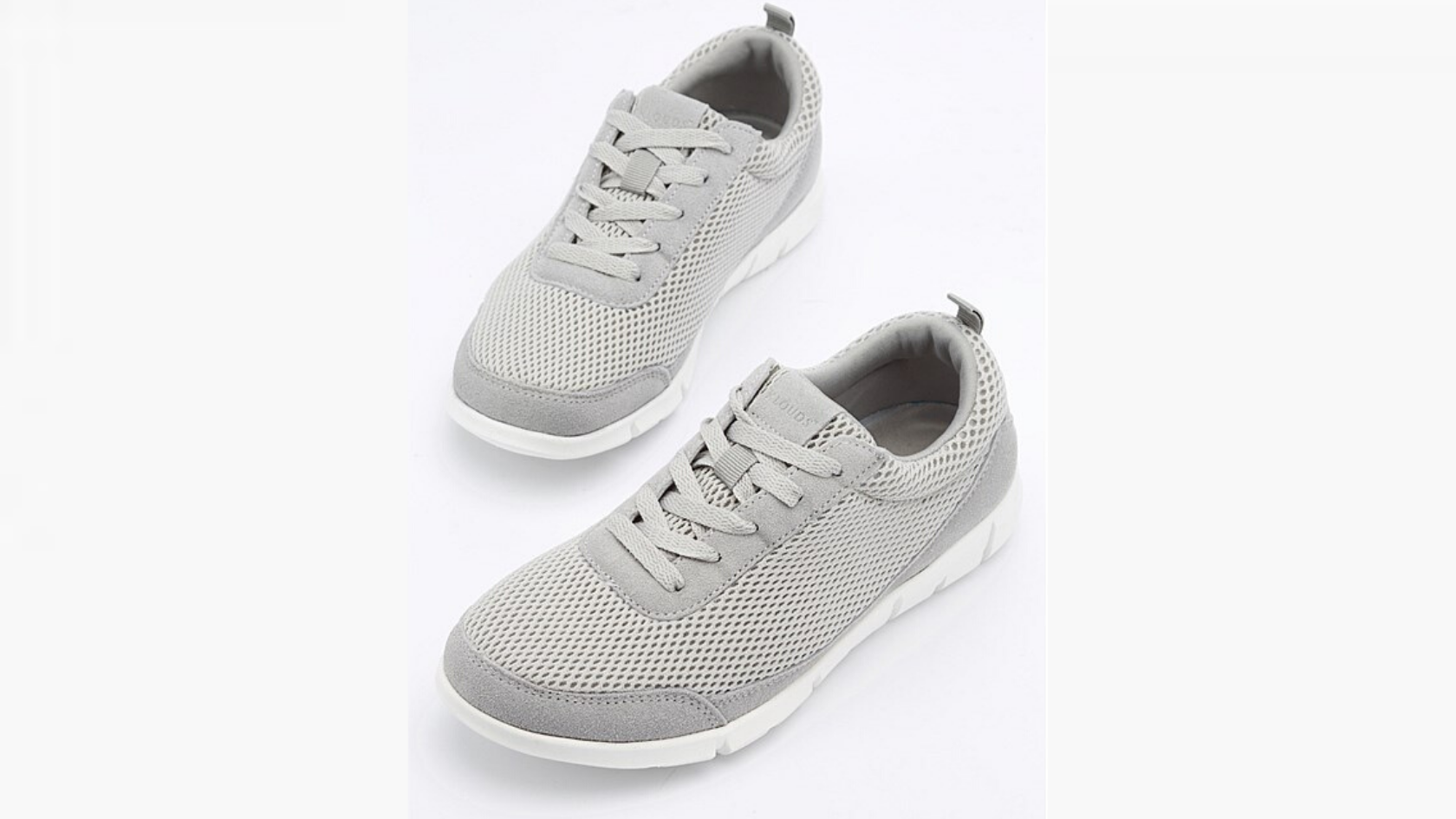 A pair of grey sneakers suspended upon a neutral background